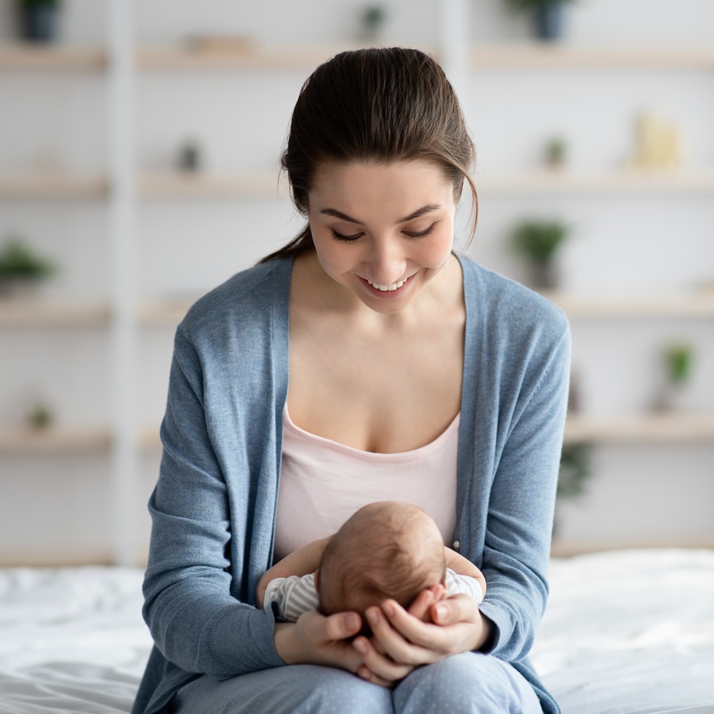 sleep consultant looking down at sleeping baby